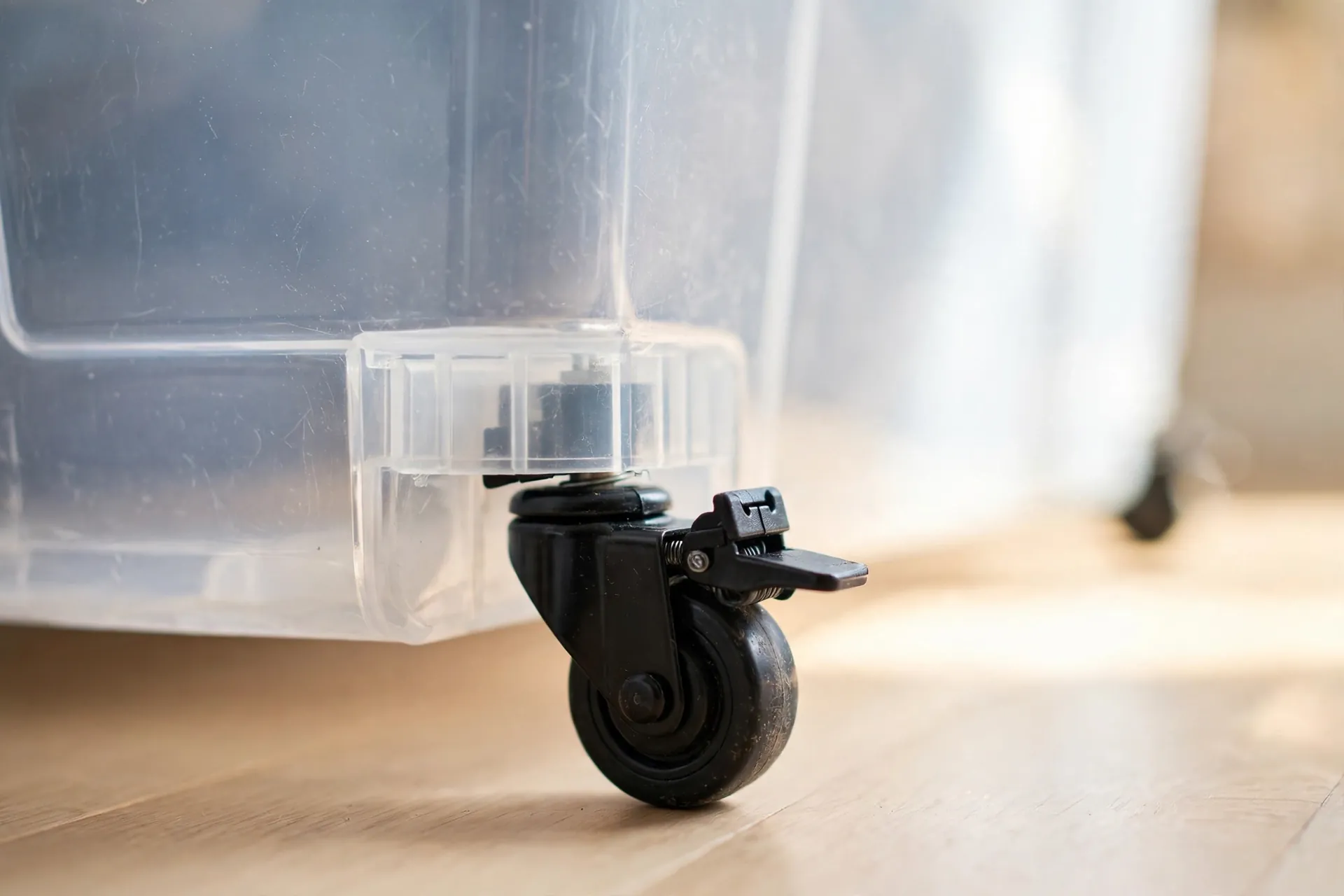 Close-up of a locking caster wheel on an under bed storage bin