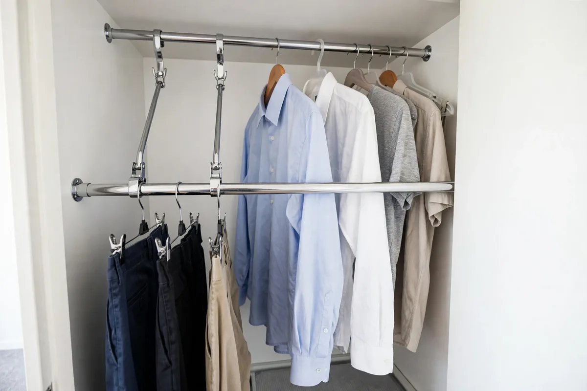 Adjustable second hanging rod installed below the main closet rod, doubling hanging space.