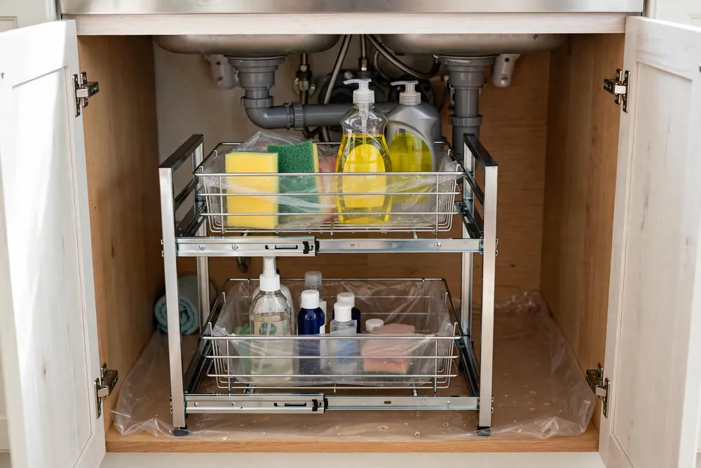 SONGMICS silver two-tier pull-out organizer with adjustable baskets under a kitchen sink
